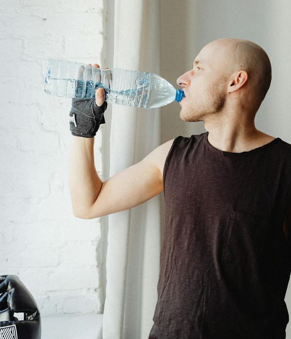 A focused man performing a balance and strength exercise.